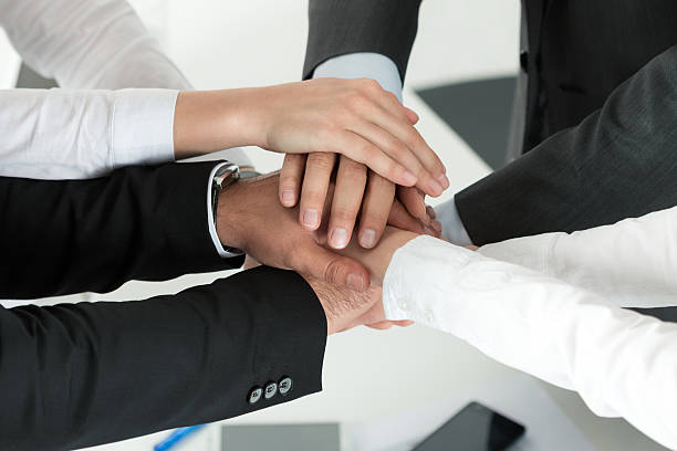 istock Business team showing unity with putting their hands together 495458316