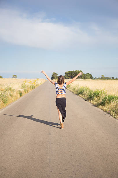 istock Gir raises hands in tyeh street 495467336