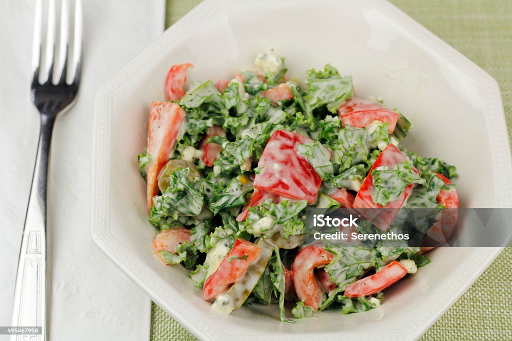 Kale and Red Pepper Salad Salad of sweet red bell peppers, green kale, jalapeno slices and blue cheese salad dressing. Dish of prepared salad of kale, red pepper, jalapeños and blue cheese dressing. 2015 Stock Photo