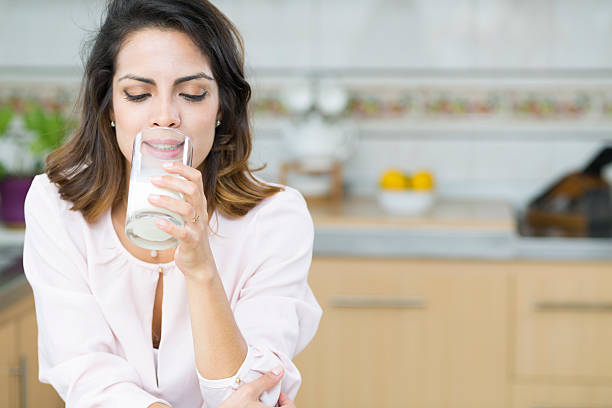 istock Attractive young woman drinking milk 495468388