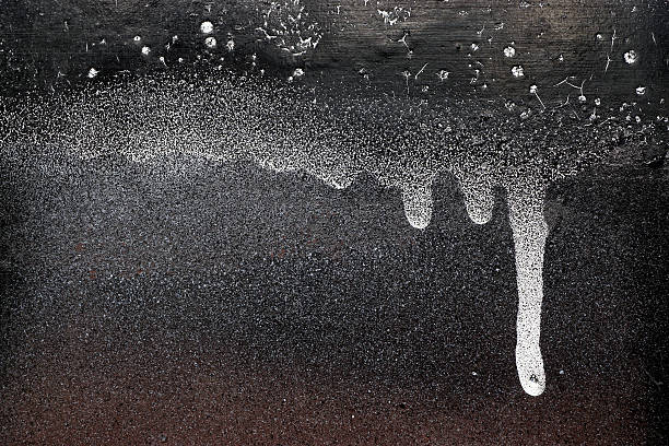 istock Rust-covered fence  with dripping black and white paint  11 495468580