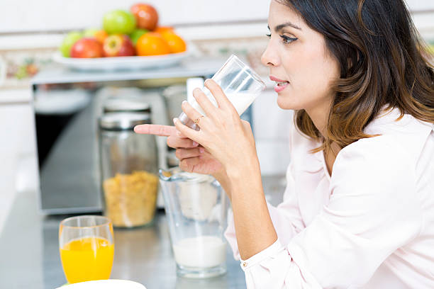 istock Attractive young woman drinking milk 495468614