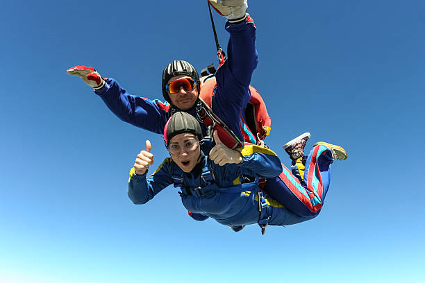 Skydiving photo. Tandem. Tandem jump. Flying in a free fall. responsibility photos stock pictures, royalty-free photos & images