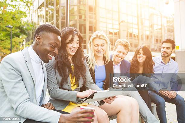 Business Group During Break Looking At Digital Tablet Stock Photo - Download Image Now