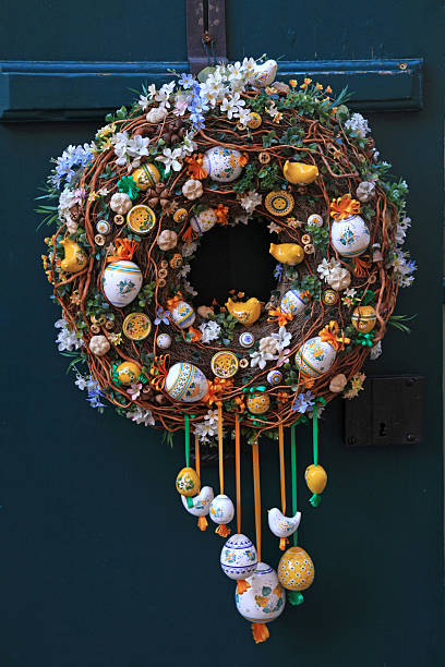 istock Easter egg wreath on a dark blue wooden door background 495471152
