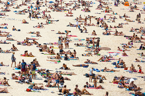 Crowded beach in hot summer day, Bondi beach Sydney Australia Crowded beach on a hot summer day, Bondi beach Sydney Australia, full frame horizontal composition bondi beach photos stock pictures, royalty-free photos & images