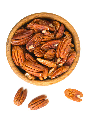 pecan nuts in a wooden bowl