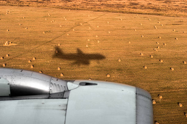 istock shadow of the airplane and jet engine 495473136