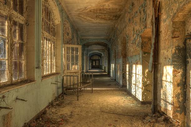 istock Abandoned hospital corridor with bed 495474035