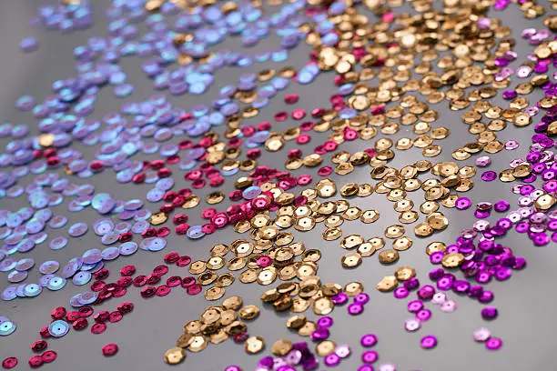 colorful sequins on a gray background