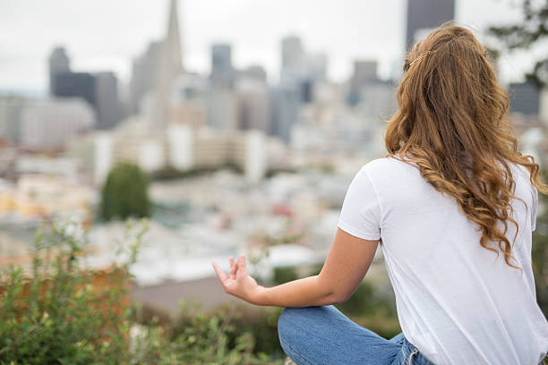 istock Woman Doing Yoga and facing the San Francisco Downtown 495478182