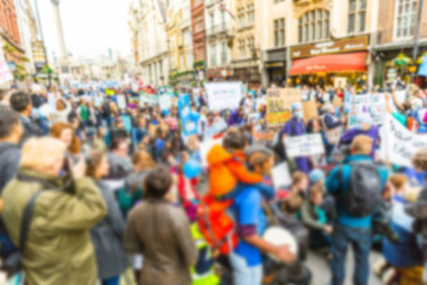 Blurred background of thousands people marching in London