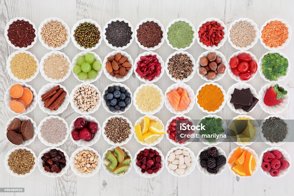 Super Food Large super food selection in porcelain crinkle bowls over distressed wooden background. High in vitamins and antioxidants. Antioxidant Stock Photo