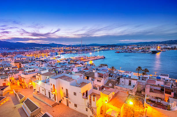 Ibiza Old Town and Harbour at dusk Elevated view over Ibiza Old Town and Harbour with ferries at dusk. balearic islands photos stock pictures, royalty-free photos & images