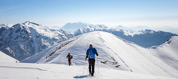 istock Mountaineer walking on snow-covered mountain ridge at high altitude 495482634