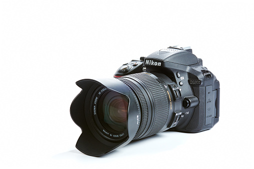 Kiev, Ukraine - November 02, 2015: Nikon D5300 DSLR Camera with Sigma 18-250 mm OS HSM Macro Lens isolated on white background.