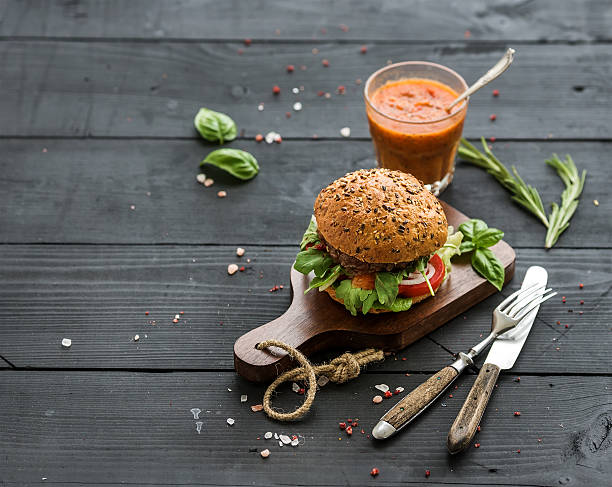 istock Fresh homemade burger on dark serving board with spicy tomato 495490078