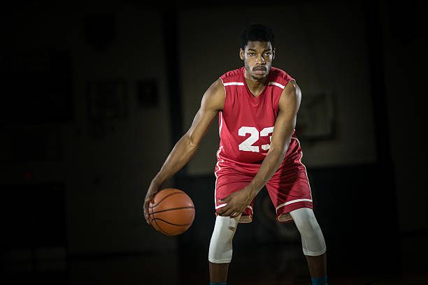 istock Young men playing basketball in a gymnasium 495490816