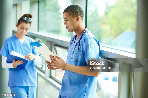 Two Young Nurses On The Ward Stock Photo - Download Image Now - Junior Doctor, Clipboard, Contemplation