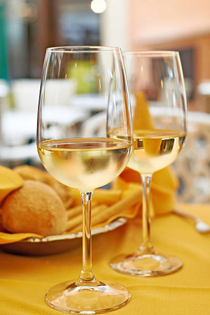 istock Glasses of white wine and salad on table cafe 495493104