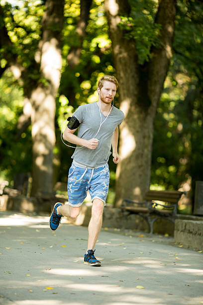 istock Young man running in the autumn park 495493272