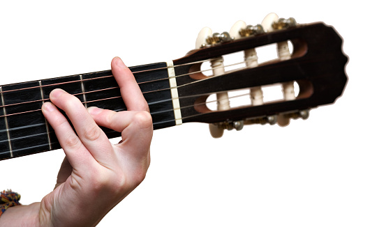 Hand of the young girl playing a guitar