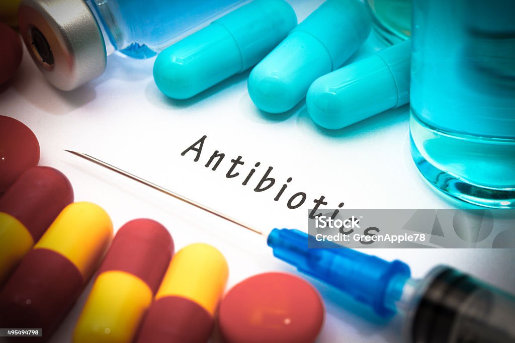 antibiotics Antibiotics - diagnosis written on a white piece of paper. Syringe and vaccine with drugs. Antibiotic Stock Photo