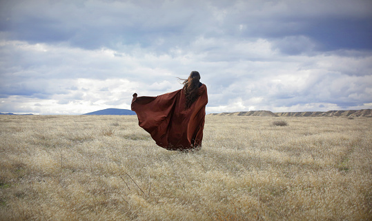 Girl in Cape Blowing in the Wind