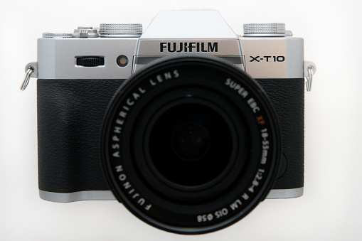 Istanbul, Turkey - November 1, 2015: Fujifim X-T10 Fujifilm Mirrorless Camera Body with 18-55 Kit lens, front view, isolated on white background.