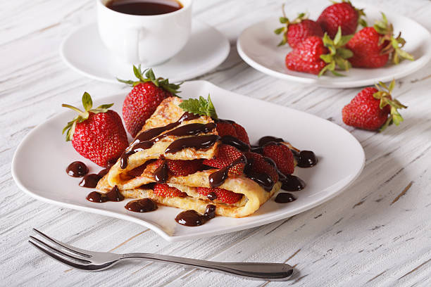 istock crepes with strawberries and coffee close-up. Horizontal 495504226