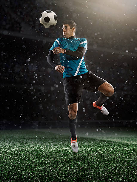 istock Soccer player kicking ball in stadium 495504568