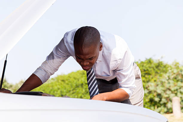 istock african businessman repairing a broken car 495505826
