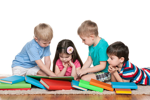 istock Four children with books on the floor 495507145