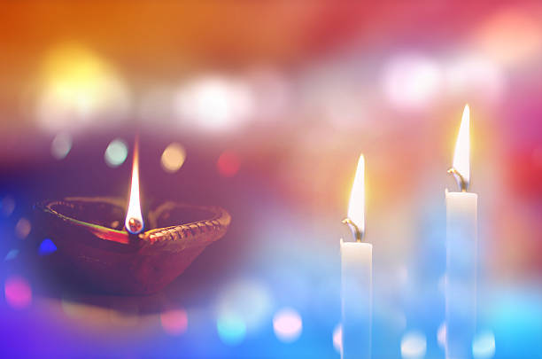 istock two candles and earthen Lamp in dark night 495507328