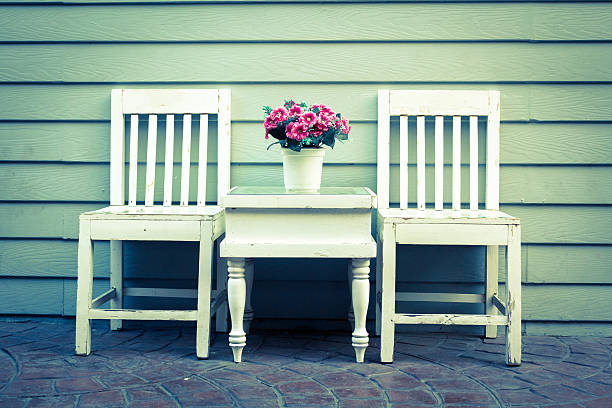 Picture of a white wooden chair for relaxing in an ornamental garden.