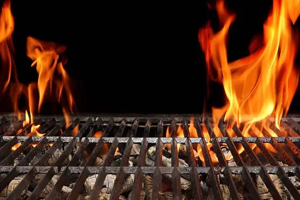 Empty Barbecue Grill With Bright Flames Closeup Isolated on Black Background With Copy Space