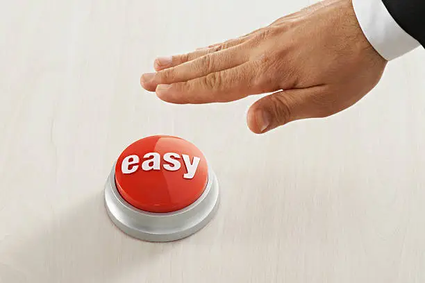 Businessman reaching red easy button.