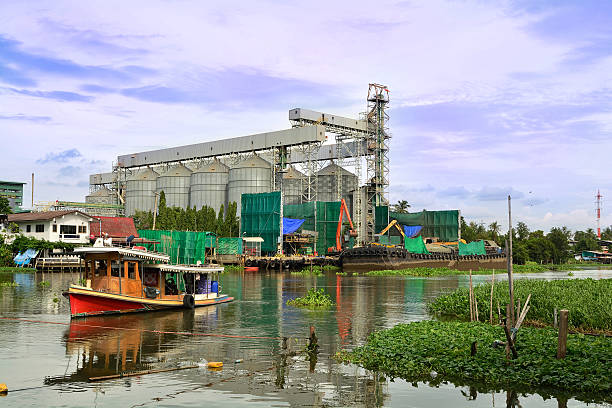 istock Dock or Port warehouse with Agricultural Silo Beside the River 495508602