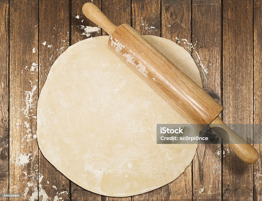 dough with rolling pin Rolled out dough on table with rolling pin Dough Stock Photo