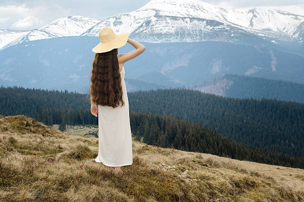 istock Young woman standing on a hillside in the mountains 495510331