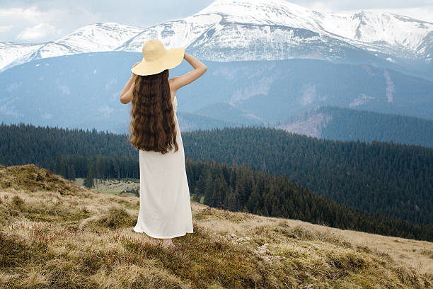 istock Young woman standing on a hillside in the mountains 495510333