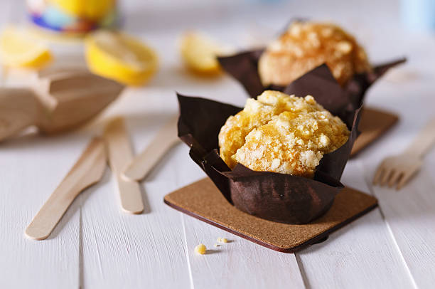 Lemon flavoured muffins on white wooden background stock photo