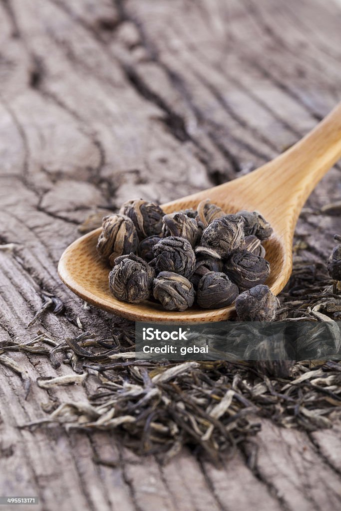 Tea leaf Tea leaf and spoon on the wood board. Black Color Stock Photo