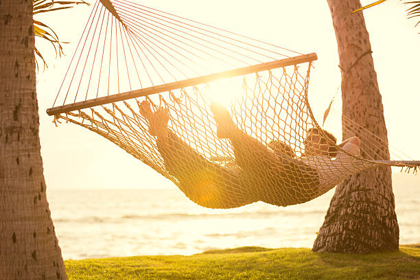 istock Couple relaxing in tropical hammock 495513763