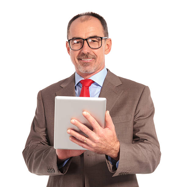 uśmiech stary biznesmen trzymając tablet komputer klawiatury - book holding necktie businessman zdjęcia i obrazy z banku zdjęć