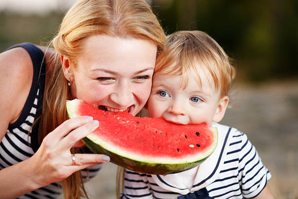istock Kid at countryside eating watermelon. 495518952