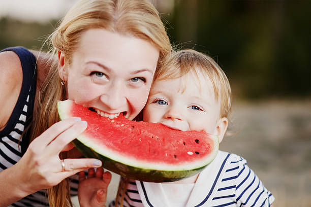 istock Kid at countryside eating watermelon. 495518972