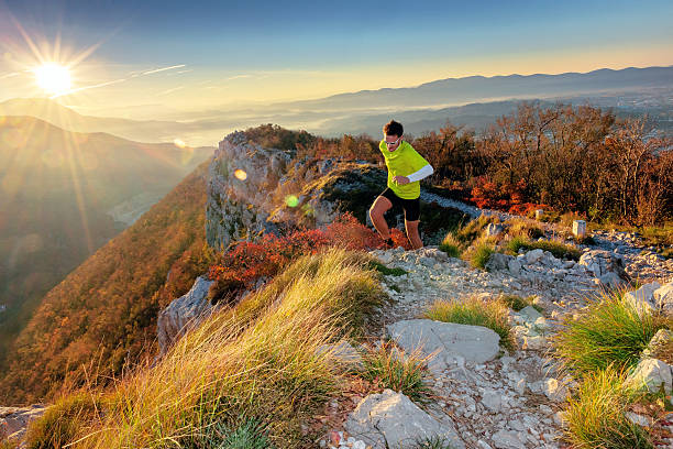 Running in the morning on the mountain, Primorska, Slovenia Young runner running  in the morning on the mountain,red smokebush,lens flare, Sabotin, Nova Gorica,Primorska, Slovenia,Nikon D3x primorska white sport nature stock pictures, royalty-free photos & images