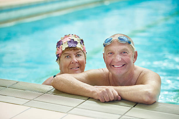 istock retired couple having fun at the swimming pool 495521866