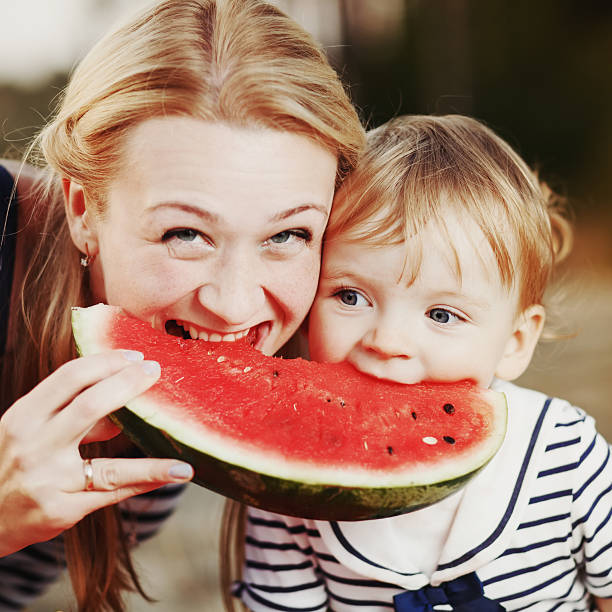 istock Kid at countryside eating watermelon. 495536466